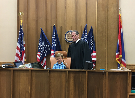 On Friday, August 3, Campbell County Health Trustee Alan Stuber was sworn in by Judge John Perry in Gillette, Wyoming. Judge Perry invited Stuber’s son Brian to the bench to make it official. 