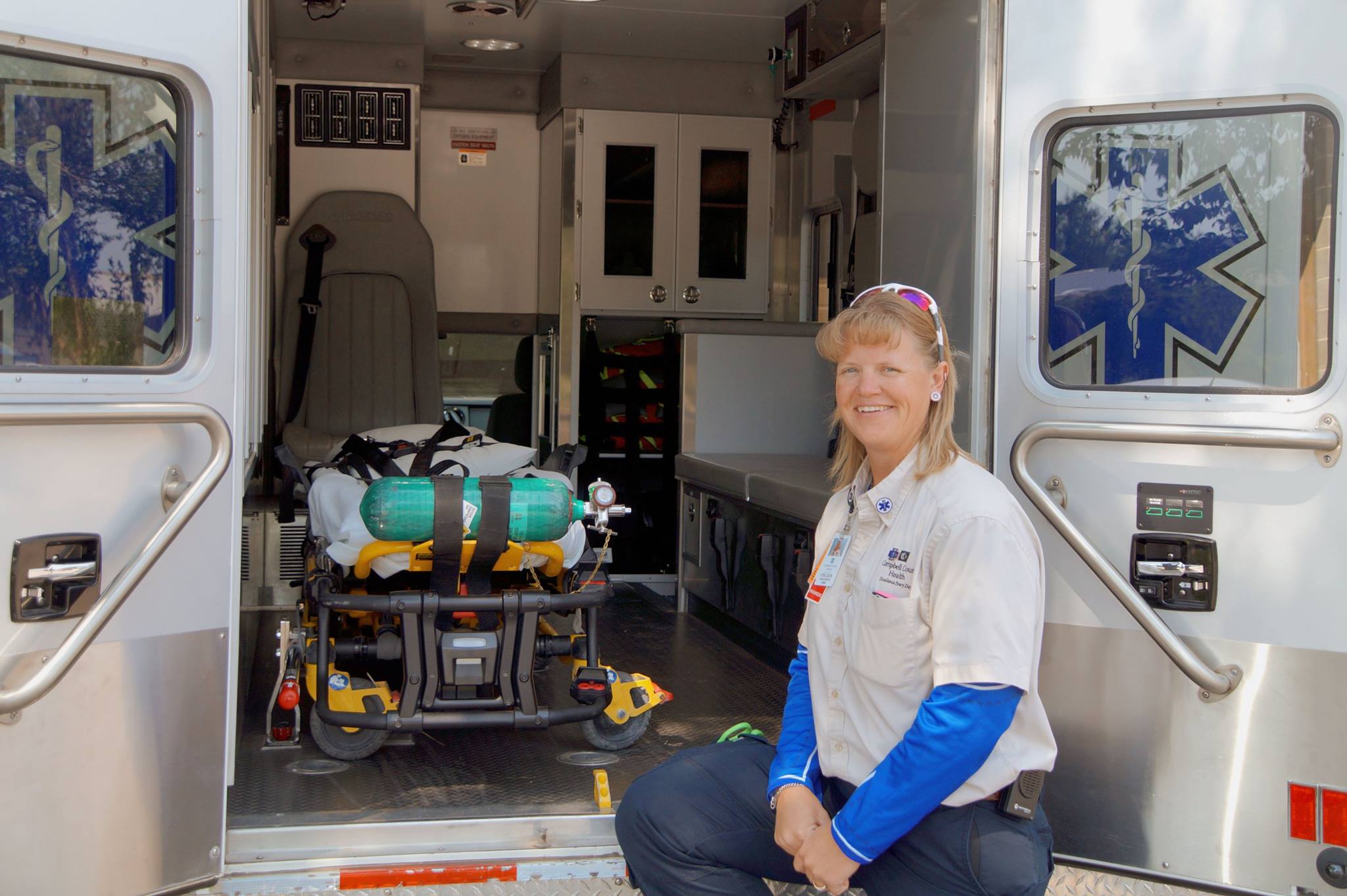 Colleen sitting on step of Ambulance